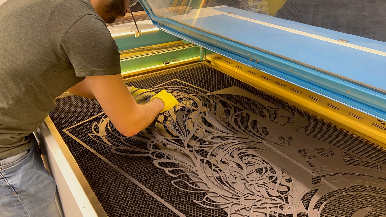 The laser cutter mid-pass on a layer of Arabesque Water.
